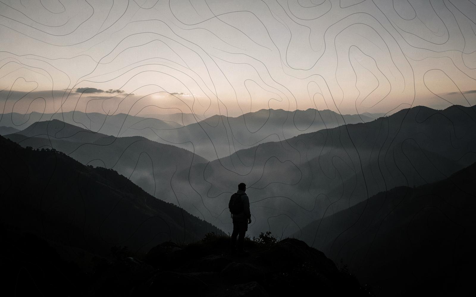 A figure at a mountain overlook studying layered terrain, with faint map contour lines in the haze